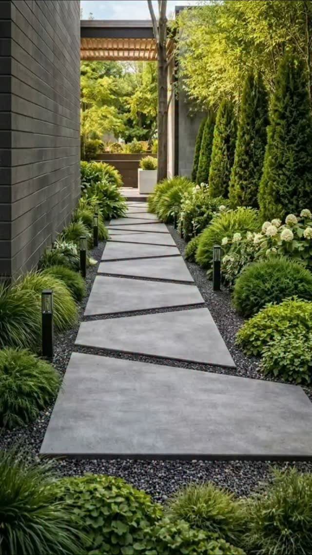 11 Backyard Ideas to Turn Your Outdoor Space Into a Place You Use 3 Large rectangular concrete pavers create a geometric pathway through a lush green garden with dark gravel borders.