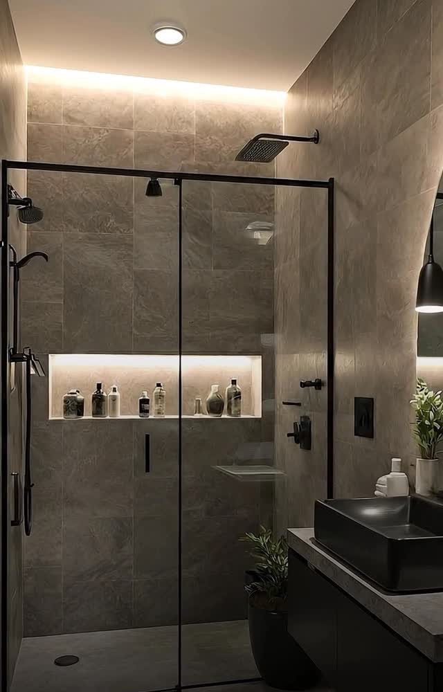 21 Bathroom Shelf Ideas That Make Tight Storage Work Harder 7 Built-in illuminated shower niche holding various bottles of toiletries inside a modern grey tiled shower.