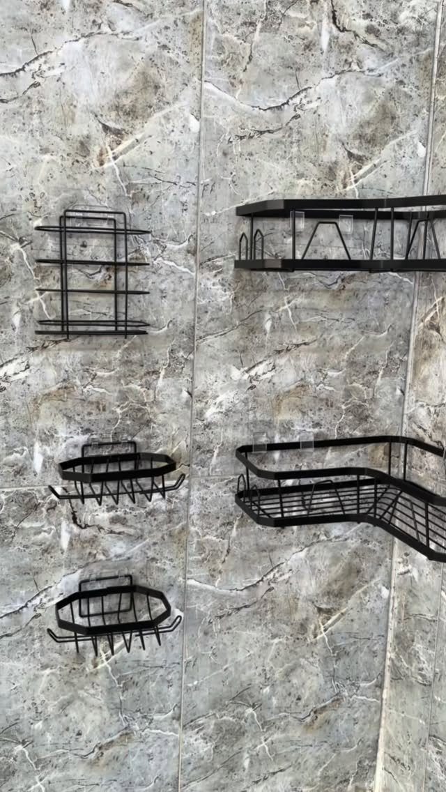 21 Bathroom Shelf Ideas That Make Tight Storage Work Harder 18 Black metal wire storage racks mounted on a grey marbled tile wall.