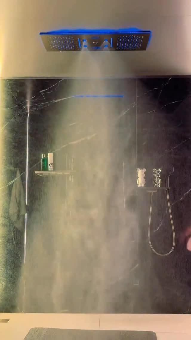 14 Bathroom Shower Ideas, From Rainfall Heads to Wet Rooms 14 Steam rises in a dark marble shower featuring a rainfall showerhead and a handheld wand.