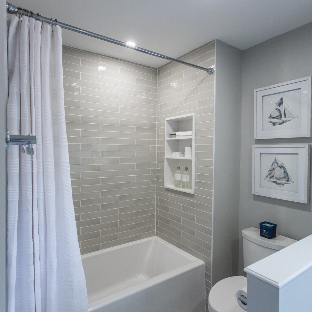 14 Bathroom Shower Ideas, From Rainfall Heads to Wet Rooms 2 White bathtub with grey subway tile walls and a white shower curtain.