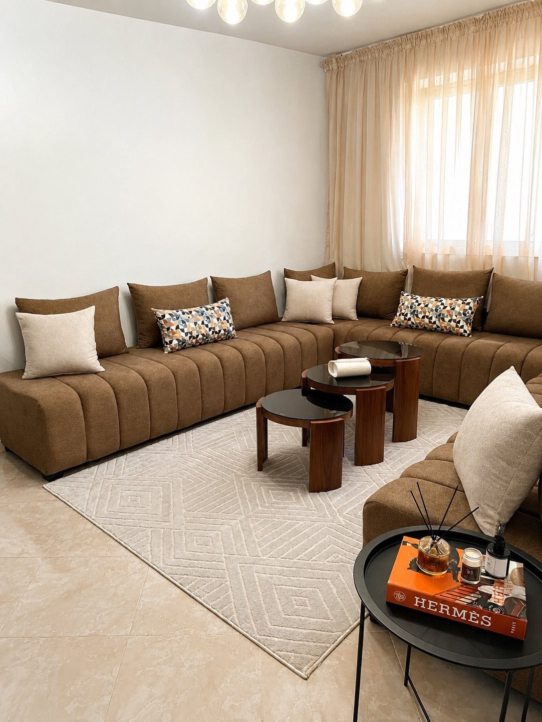 A large brown modular sectional sofa with patterned pillows in a modern living room.