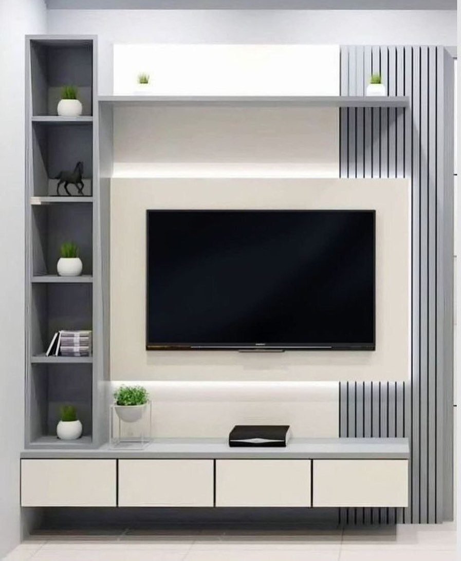 A black flat-screen television mounted on a beige wall panel within a modern grey and white entertainment unit.