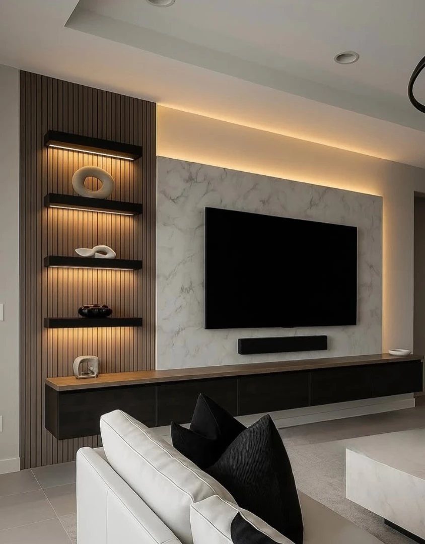 Modern media wall with marble paneling, wood slats, and illuminated floating black shelves.